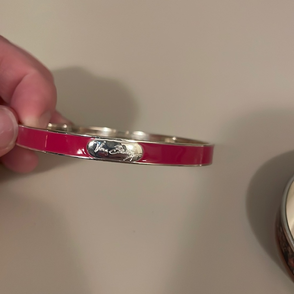2 Vera Bradley metal bangles. One is pink and one is floral.